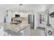 Bright kitchen featuring granite counters, stainless steel appliances, and a convenient breakfast bar at 1250 N Portofino Dr # 304, Sarasota, FL 34242