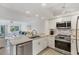 Modern kitchen with stainless steel appliances and granite countertops is open to the living area at 1250 N Portofino Dr # 304, Sarasota, FL 34242