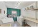 Functional laundry room equipped with washer, dryer, utility sink and shelving at 1250 N Portofino Dr # 304, Sarasota, FL 34242