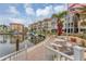 Relaxing waterfront patio area with tables and chairs, overlooking the boat docks and condo buildings at 1250 N Portofino Dr # 304, Sarasota, FL 34242