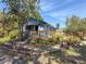 Charming home with a wooden deck, mature trees, and a garden with unique landscaping at 1350 40Th St, Sarasota, FL 34234