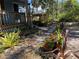 Scenic backyard with bromeliads, stone pavers, and wooden decks offering a serene and inviting outdoor retreat at 1350 40Th St, Sarasota, FL 34234