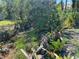 Backyard oasis featuring a serene stream bordered by lush greenery, plants, and trees for a tranquil setting at 1350 40Th St, Sarasota, FL 34234