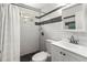 Updated bathroom featuring black and white tile and shower with curtain at 1350 40Th St, Sarasota, FL 34234