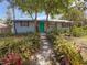 Charming home with a lush landscaped yard and a stone walkway leading to the front door at 1350 40Th St, Sarasota, FL 34234