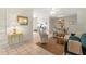 Bright living room featuring white tile floors, a comfortable seating arrangement, and open dining area at 1350 40Th St, Sarasota, FL 34234