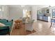 Spacious living room featuring tile floors, bright lighting, and access to the kitchen, perfect for entertaining at 1350 40Th St, Sarasota, FL 34234