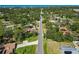 A long street cuts through a neighborhood of lush foliage leading to distant waterfront views at 1621 Overbrook Rd, Englewood, FL 34223