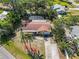 Lovely single-story home features a screened-in pool, pergola, and mature landscaping at 1621 Overbrook Rd, Englewood, FL 34223