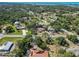 An aerial view showcases an established residential community with mature trees at 1621 Overbrook Rd, Englewood, FL 34223