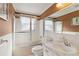 Bathroom features a shower-tub combo and vanity with marble-style countertop at 1621 Overbrook Rd, Englewood, FL 34223