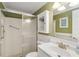 This bathroom includes a shower and a white vanity with lots of storage at 1621 Overbrook Rd, Englewood, FL 34223