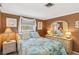 This stylish bedroom features ample natural light, a coastal theme, and charming decor at 1621 Overbrook Rd, Englewood, FL 34223