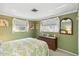 This bedroom features twin windows and charming decor at 1621 Overbrook Rd, Englewood, FL 34223