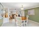 Bright dining room with elegant chandelier, fireplace, and open access to the comfortable living area at 1621 Overbrook Rd, Englewood, FL 34223