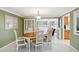 Dining room with a display cabinet opens to the living room and is adjacent to kitchen at 1621 Overbrook Rd, Englewood, FL 34223