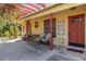 Charming covered patio entrance with seating and outdoor decor at 1621 Overbrook Rd, Englewood, FL 34223