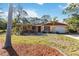 Charming single-story home with a well-maintained lawn and cozy front patio at 1621 Overbrook Rd, Englewood, FL 34223