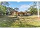 Quaint single-story home with mature trees and a well-kept lawn at 1621 Overbrook Rd, Englewood, FL 34223