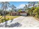 Single-story home featuring a well-manicured lawn and long driveway at 1621 Overbrook Rd, Englewood, FL 34223