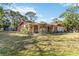 Lovely single-story home featuring mature trees and a lush green lawn at 1621 Overbrook Rd, Englewood, FL 34223