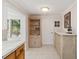 Bright hallway with built-in display cabinet and storage, offering a glimpse into the kitchen at 1621 Overbrook Rd, Englewood, FL 34223