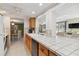 Open kitchen with lots of natural light, oak cabinets, and a breakfast bar overlooking the seating area at 1621 Overbrook Rd, Englewood, FL 34223