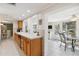 Bright kitchen with breakfast bar and view into the dining and Gathering rooms, creating an airy atmosphere at 1621 Overbrook Rd, Englewood, FL 34223
