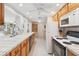 Bright kitchen with ample counter space, white appliances, and classic wooden cabinets at 1621 Overbrook Rd, Englewood, FL 34223