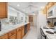 Bright kitchen offering oak cabinets, and a view to a seating area, creating an airy atmosphere at 1621 Overbrook Rd, Englewood, FL 34223