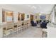 Open floor plan featuring a breakfast bar, tile flooring, and a comfortable living area with ceiling fan at 1621 Overbrook Rd, Englewood, FL 34223