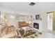 Bright living room with decorative fireplace and cozy seating, with access to other rooms at 1621 Overbrook Rd, Englewood, FL 34223