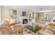 Inviting living room with a fireplace, comfortable seating, and open access to dining area at 1621 Overbrook Rd, Englewood, FL 34223