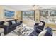 Cozy living area with ample natural light, comfortable seating, and nautical-themed decor at 1621 Overbrook Rd, Englewood, FL 34223