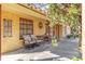 Covered outdoor patio with seating and view of the front yard at 1621 Overbrook Rd, Englewood, FL 34223
