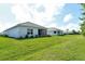 A well-maintained lawn and lush landscaping, complemented by a screened-in lanai for comfortable outdoor living at 18249 Vizcaya Ct, Venice, FL 34293