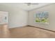 Bright bedroom features hardwood floors, a ceiling fan, and a large window at 18249 Vizcaya Ct, Venice, FL 34293