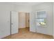 Inviting bedroom with an open doorway and natural light from the window at 18249 Vizcaya Ct, Venice, FL 34293