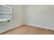 Bright, airy bedroom showcasing hardwood floors and a sun-lit window at 18249 Vizcaya Ct, Venice, FL 34293