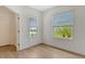 Bright bedroom featuring dual windows offering views of lush greenery at 18249 Vizcaya Ct, Venice, FL 34293