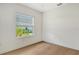 Sunlit bedroom with hardwood flooring and a serene outdoor view at 18249 Vizcaya Ct, Venice, FL 34293