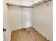 Walk-in closet features a hanging rack and wood floor at 18249 Vizcaya Ct, Venice, FL 34293