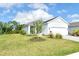 Landscaped front yard with green grass, trees, and plants accentuates this single Gathering home at 18249 Vizcaya Ct, Venice, FL 34293