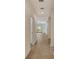 The spacious hallway features wood floors and a view to a living space with sliding glass doors at 18249 Vizcaya Ct, Venice, FL 34293