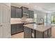 Kitchen featuring stainless appliances, stylish gray cabinets, and sleek countertops and floors at 18249 Vizcaya Ct, Venice, FL 34293