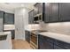 Close-up of the kitchen with stainless appliances, gray cabinets, and sleek countertops at 18249 Vizcaya Ct, Venice, FL 34293
