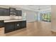 Kitchen featuring stainless steel appliances, gray cabinets, a large island, and an exterior view at 18249 Vizcaya Ct, Venice, FL 34293