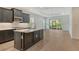Modern kitchen featuring a center island, stainless steel appliances, and seamless access to the living area at 18249 Vizcaya Ct, Venice, FL 34293