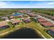 Expansive aerial view showcasing homes, lush landscaping, and serene waterfront settings within the community at 20655 Valprato Ct, Venice, FL 34293