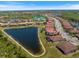 Aerial view of the house showcasing its location near a lake and beautiful neighborhood with well-manicured lawns at 20655 Valprato Ct, Venice, FL 34293